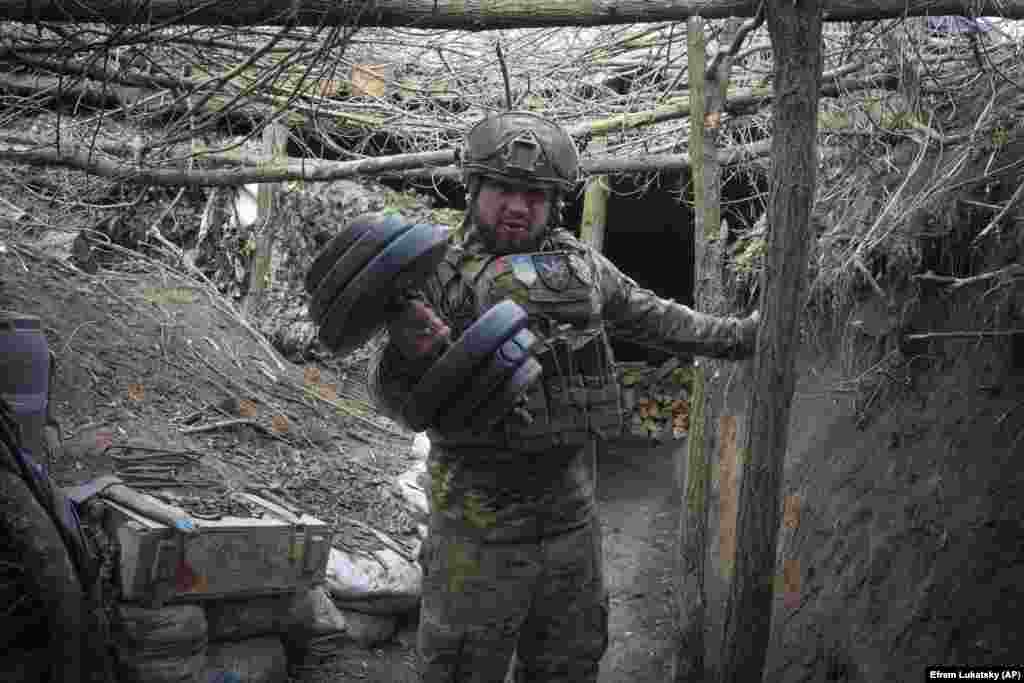 Украинский военный с гантелей в окопе 