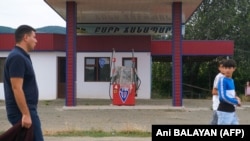 Nagorno-Karabakh - People walk past a closed gas station in Askeran, July 18, 2023.