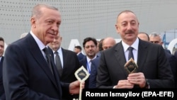 Turkish President Recep Tayyip Erdogan (L) and Azerbaijani President Ilham Aliyev attend a ceremony for the opening of a new international airport in Zangilan, one of the districts that Azerbaijan regained control of during the 2020 war in Nagorno-Karabakh. October 20, 2022.