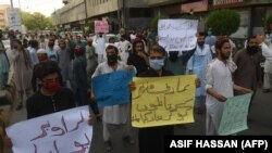 Supporters of the Pashtun Tahafuz Movement hold placards during a protest against the killing of a party leader Arif Wazir, in Karachi on May 5, 2020.