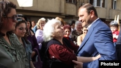 Armenia - Yerevan Mayor Taron Markarian (R) is greeted by supporters during an election campaign meeting in the city's Arabkir district, 30Apr2013.