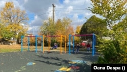 Kyrylo (left) and some friends play on the swings at the Raze de Soare center.