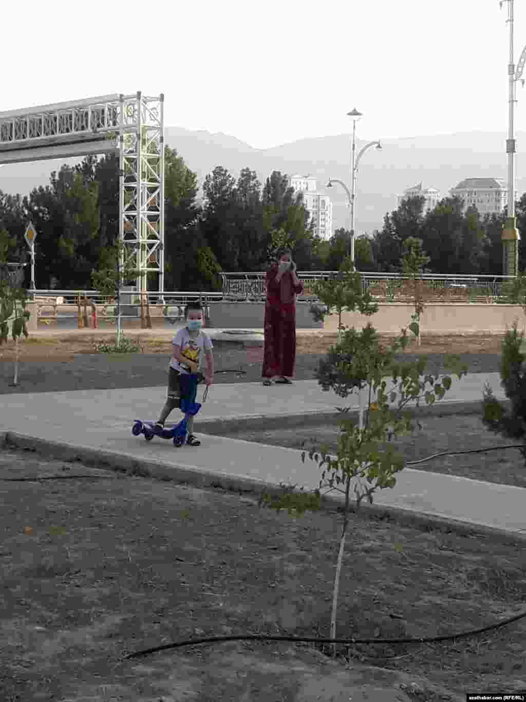 Aşgabat. Ejesiniň gözegçiliginde tigir sürüp oýnaýan oglanjyk. Iýul, 20202. 