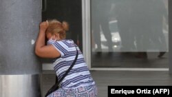 Femeie care plânge după ce a aflat de decesul unei rude infectate cu coronavirus