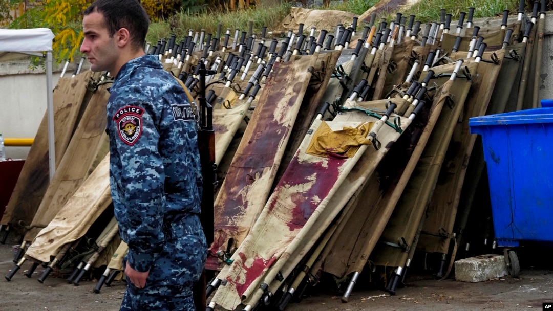 A policeman walks past blood-stained stretchers at a morgue in Stepanakert, the main city in Nagorno-Karabakh, on November 6.