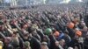 People cheer as they listen to police officers from Lviv who have joined the antigovernment protests during a rally on Independence Square in Kyiv on February 21.