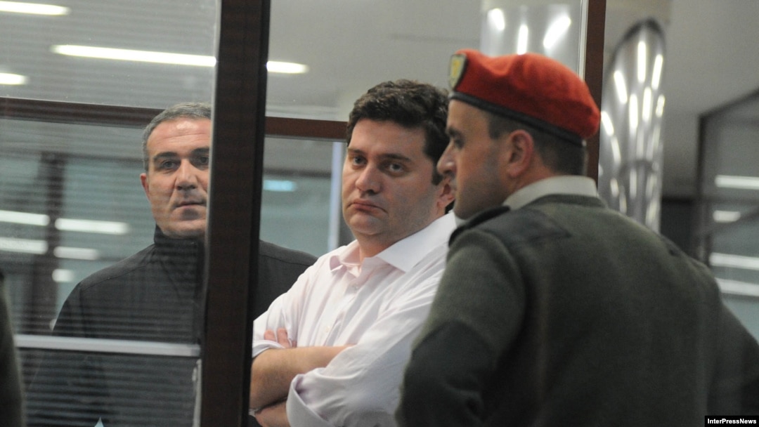 Georgian former Interior Minister Bacho Akhalaia (center) in police custody. 