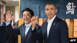 U.S. President Barack Obama (right) being greeted by Japanese Prime Minister Shinzo Abe after arriving in Japan on April 23