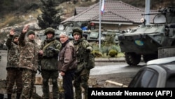 NAGORNO-KARABAKH -- Russian peacekeepers (R and 3rdR) stop a car at their checkpoint outside the city of Stepanakert, November 13, 2020