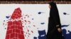 Tehran, Iran - A woman walks past an anti U.S. mural on the former U.S. Embassy's wall in Tehran, Iran January 7, 2020. Nazanin Tabatabaee/WANA (West Asia News Agency) via REUTERS
