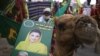 Supporters of opposition political party Pakistani Muslim League (Nawaz) hold a picture of leader Maryam Nawaz Sharif during an anti-government rally in Karachi on October 18.