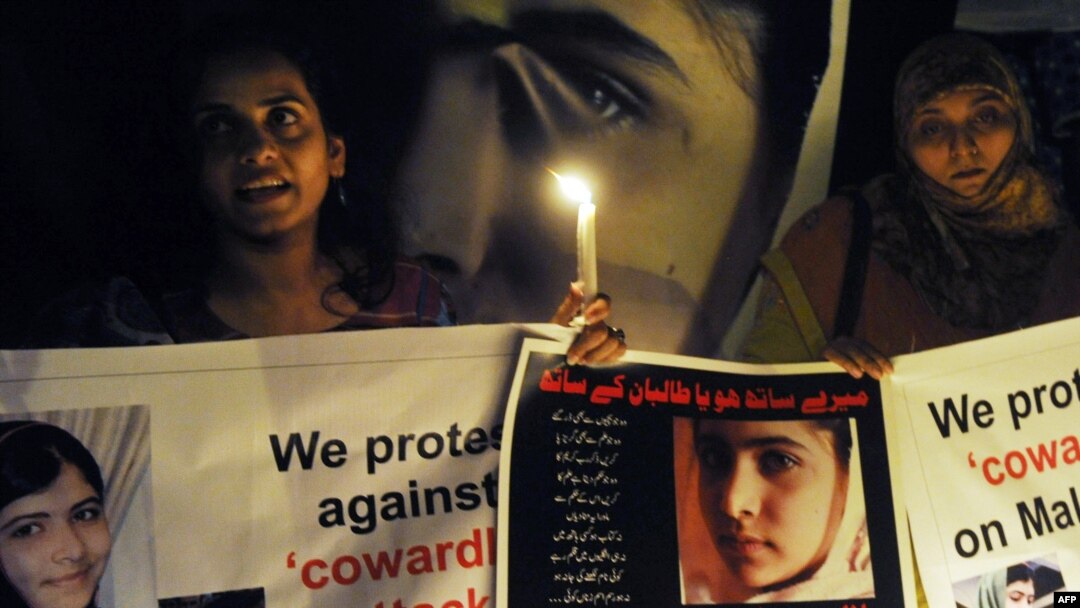 Pakistani civil society activists carry candles to pay tribute to Malala Yousafzai in Lahore.