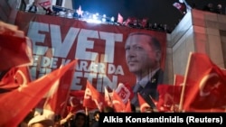 Supporters of Turkish President Recep Tayyip Erdogan celebrate at the ruling party headquarters in Istanbul on April 16.