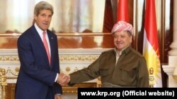 Kurdish leader Masud Barzani (right) meets with U.S. Secretary of State John Kerry in Irbil on June 24.