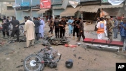 Pakistani security officials examine the site of a deadly bomb blast in Dera Ismail Khan on November 3.