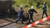 Russian rescue workers remove a body bag at the site of a deadly fire that razed a psychiatric hospital in Novgorod Oblast, killing at least 37 people.
