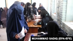FILE: Afghan women cast their ballots votes during the Parliamentary elections in Kandahar, Afghanistan, 27 October 2018.