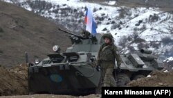 NAGORNO-KARABAKH -- Russian soldiers of the peacekeeping force man a checkpoint on a road outside the city of Stepanakert, November 26, 2020
