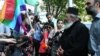 Изъятие нежелательного перечня из антидискриминационного законопроекта не смягчило гнев духовных лиц. Сегодня они устроили акции протеста возле тбилисского и кутаисского зданий парламента, где вновь грозили депутатам анафемой
