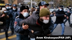 ARMENIA -- Police detain demonstrators during a rally demanding the resignation of Prime Minister Nikol Pashinian over his handling of the conflict with Azerbaijan, December 8, 2020.