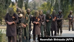FILE: Officials of Afghanistan's National Directorate Security (NDS) intelligence agency escort alleged Taliban fighters after they are presented to media in Jalalabad in January.