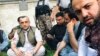 Amrullah Saleh (L) surrounded by his supporters after the attack 