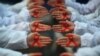 CHINA -- Students hold red ribbons during an event to mark World AIDS Day at a medical college in Yangzhou, Jiangsu province,November 30, 2017